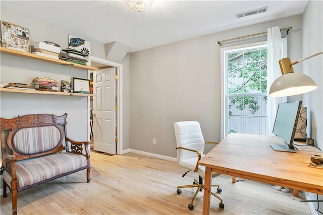 office featuring light wood-style floors, baseboards, and visible vents