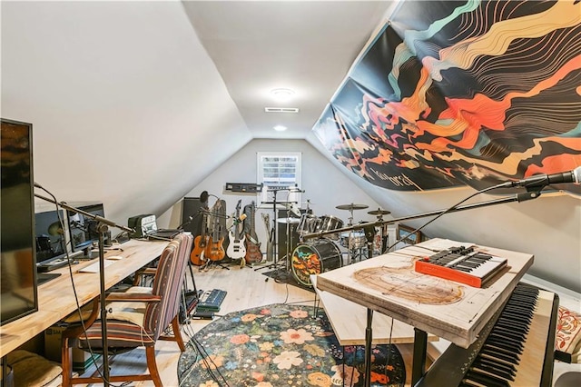 interior space with lofted ceiling, wood finished floors, and visible vents