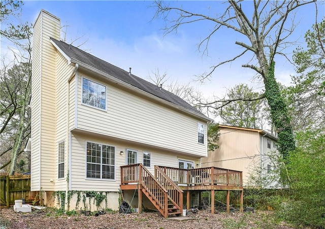 back of property featuring stairway, a chimney, fence, and a wooden deck