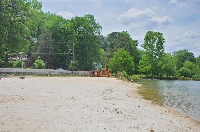 exterior space with playground community and a water view