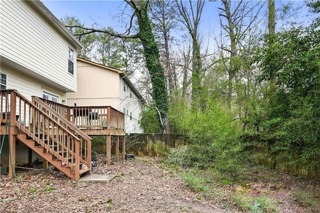 view of yard featuring stairs, fence, and a wooden deck