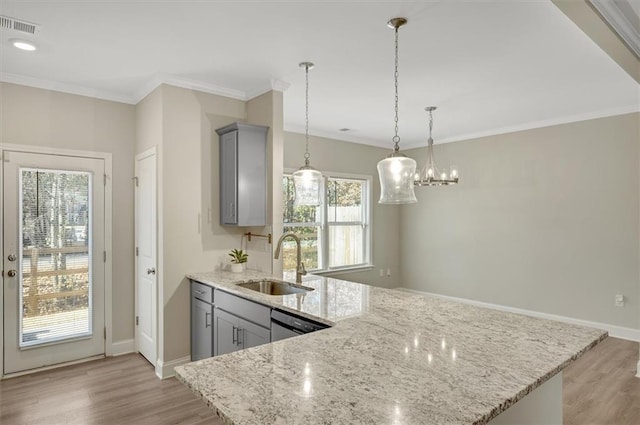 kitchen featuring gray cabinetry, sink, decorative light fixtures, and light stone countertops