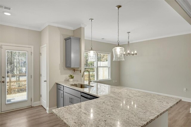 kitchen with dishwasher, sink, gray cabinetry, and light stone counters