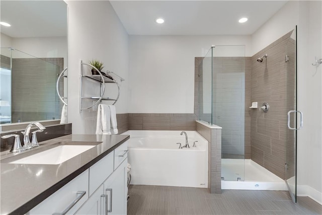 bathroom with vanity and separate shower and tub