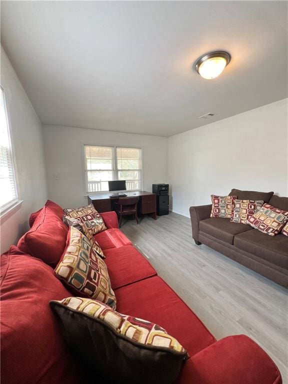 living room with visible vents and light wood-style floors