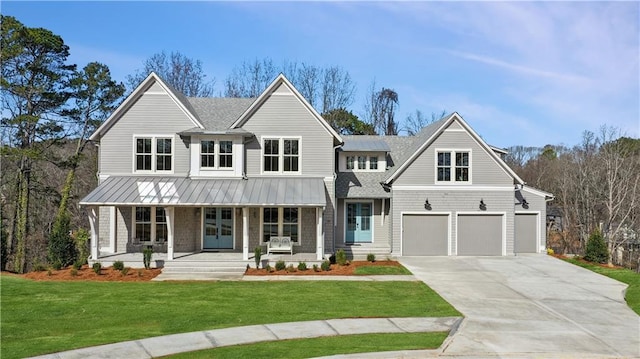 view of front of house featuring a porch, a garage, and a front yard