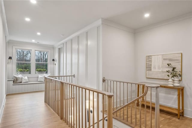 corridor featuring crown molding and light wood-type flooring