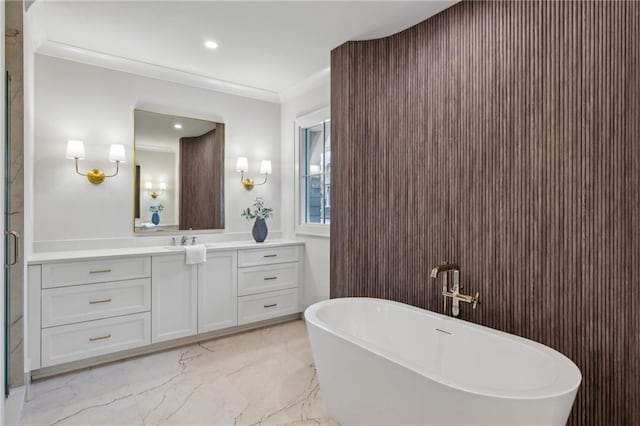 bathroom with vanity, ornamental molding, and a bathing tub