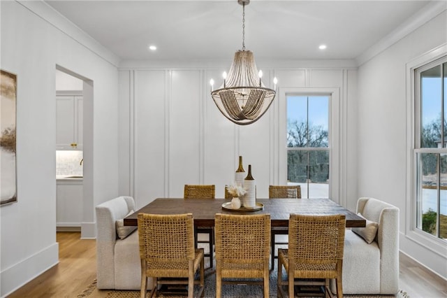 dining area featuring a chandelier and light hardwood / wood-style flooring