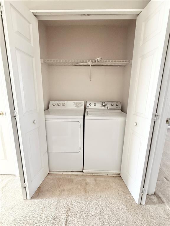 laundry room with laundry area and washing machine and clothes dryer