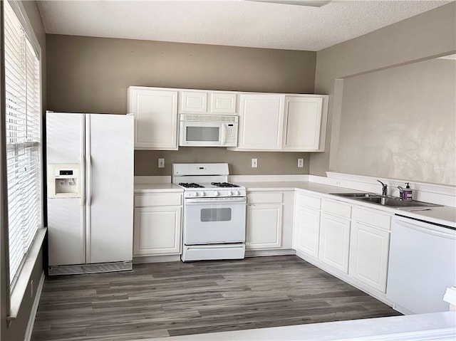 kitchen featuring white appliances and white cabinetry