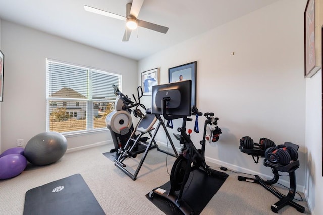 workout area with carpet floors, a ceiling fan, and baseboards