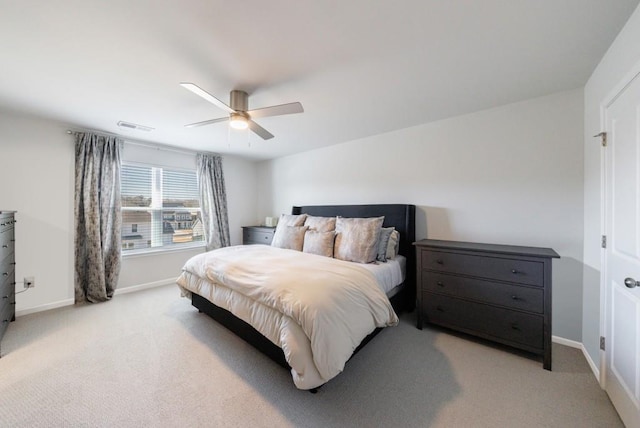 bedroom featuring light carpet, a ceiling fan, visible vents, and baseboards