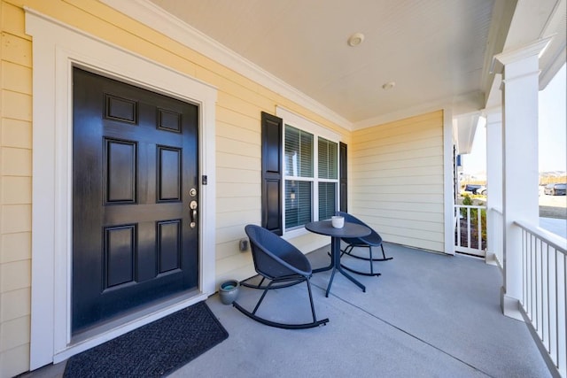 view of exterior entry featuring a porch