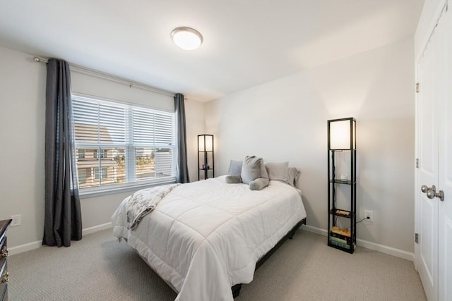 bedroom with carpet floors and baseboards