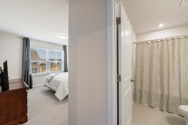 carpeted bedroom featuring baseboards, recessed lighting, visible vents, and tile patterned floors