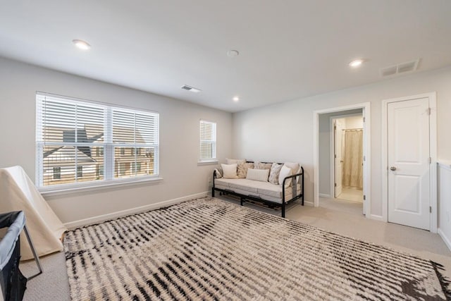 sitting room with light colored carpet, visible vents, baseboards, and recessed lighting