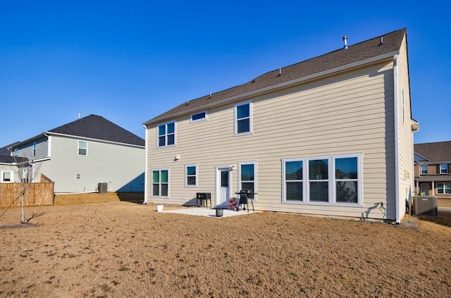 back of property with fence, central AC, and a patio