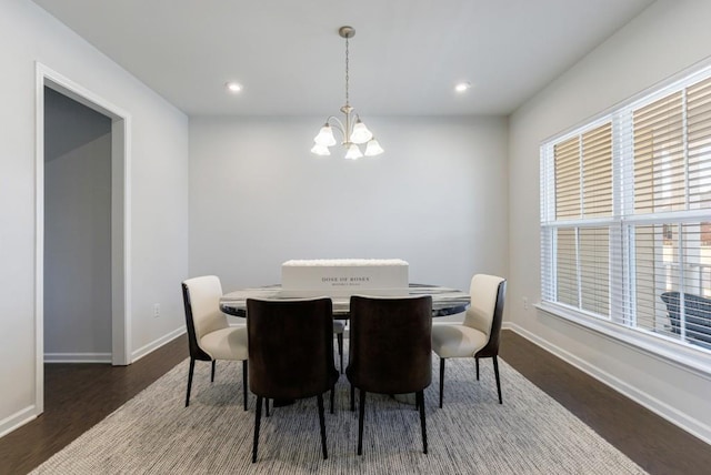 dining room with baseboards, recessed lighting, wood finished floors, and an inviting chandelier