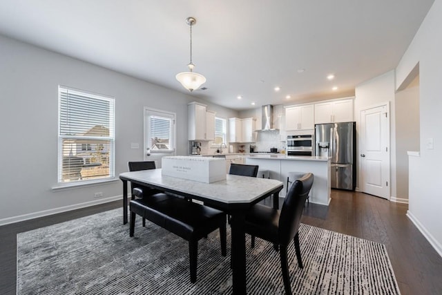 dining room featuring baseboards, dark wood-style flooring, and recessed lighting