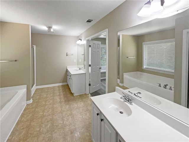 bathroom featuring shower with separate bathtub and vanity