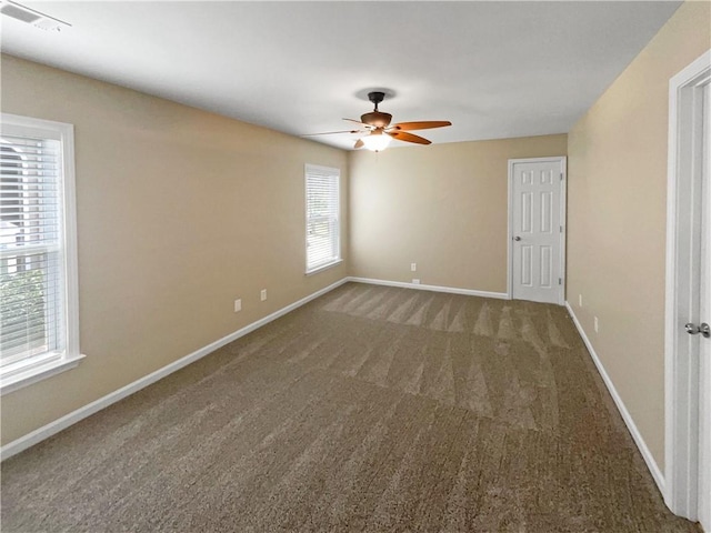 empty room with ceiling fan and carpet flooring