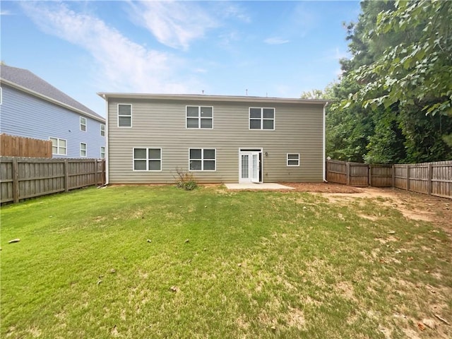 rear view of house with a lawn