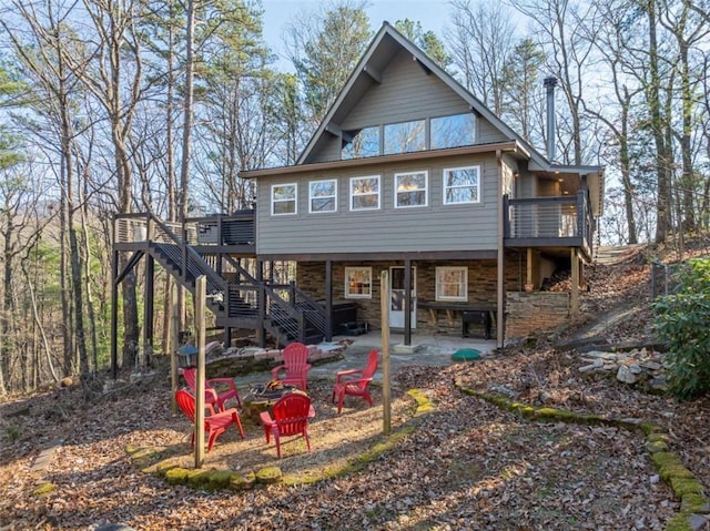 60 Laurel Ridge Ct, Ellijay, GA 30540 - back of property featuring a fire pit, stairs, a patio area, stone siding, and a wooden deck
