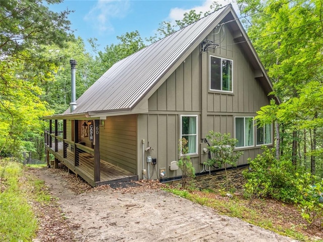 60 Laurel Ridge Ct, Ellijay, GA 30540 - view of home's exterior featuring board and batten siding, metal roof, and a wooden deck