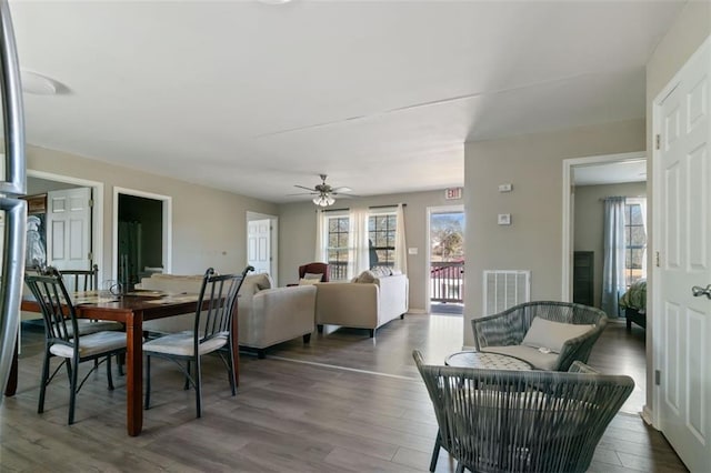 dining space with hardwood / wood-style flooring and ceiling fan