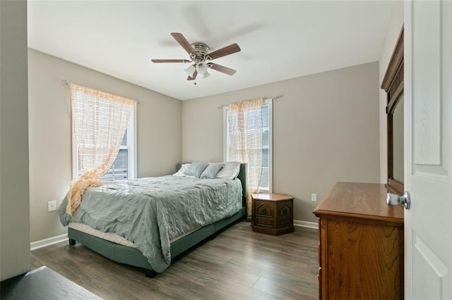 bedroom with ceiling fan and dark hardwood / wood-style floors