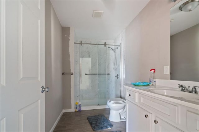 bathroom featuring walk in shower, vanity, and toilet