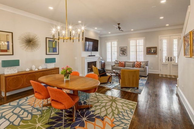 dining space featuring wood finished floors, a chandelier, recessed lighting, baseboards, and ornamental molding