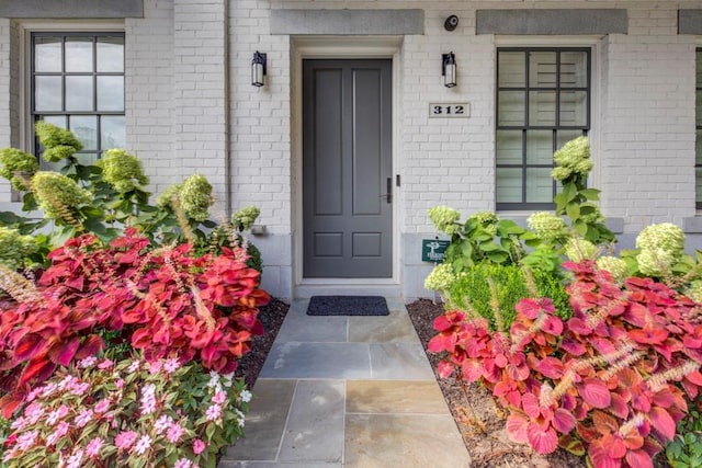 entrance to property with brick siding