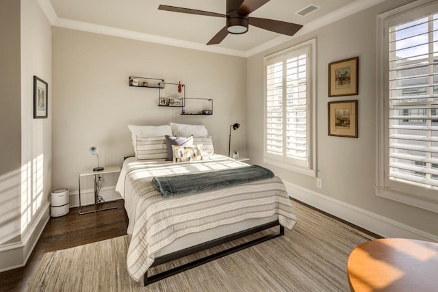 bedroom with wood finished floors, baseboards, ornamental molding, and ceiling fan