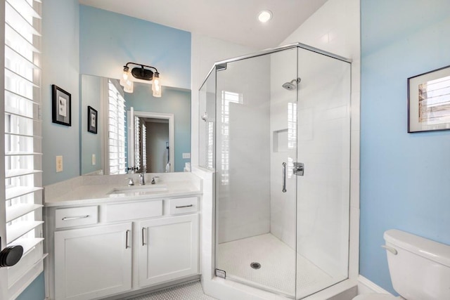 full bathroom featuring healthy amount of natural light, toilet, a shower stall, vanity, and recessed lighting