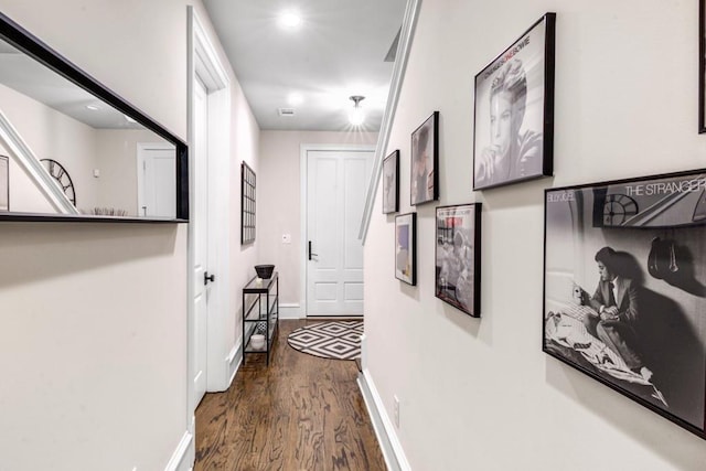 corridor featuring dark wood-style floors, baseboards, and recessed lighting