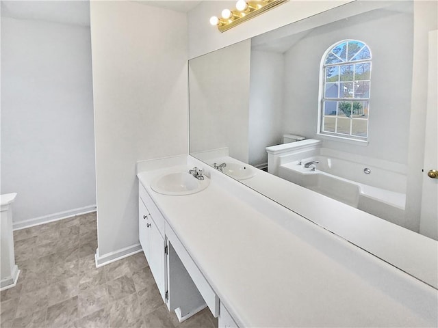 bathroom with vanity and a tub