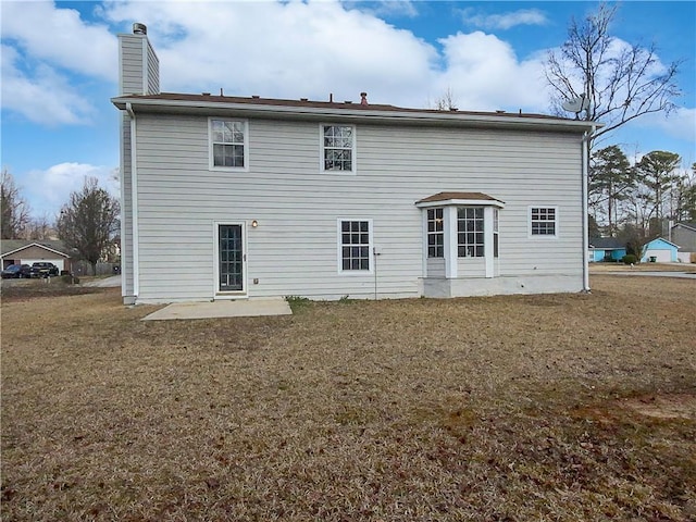 back of house with a yard and a patio area