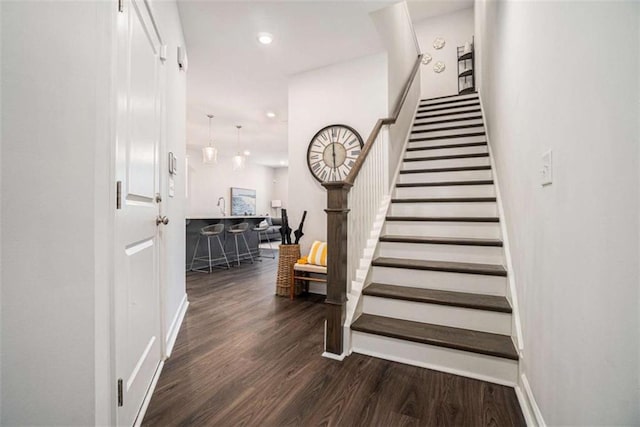 stairs featuring recessed lighting, baseboards, and wood finished floors