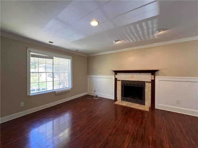 unfurnished living room featuring a fireplace, ornamental molding, and dark hardwood / wood-style floors