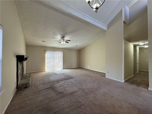 unfurnished living room with ceiling fan, a brick fireplace, a textured ceiling, and carpet flooring