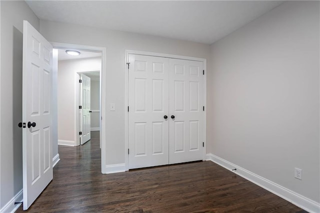 5096 Limerick Ln, Flowery Branch, GA 30542 - unfurnished bedroom featuring baseboards, dark wood finished floors, and a closet
