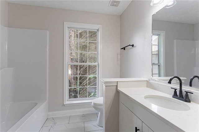 5096 Limerick Ln, Flowery Branch, GA 30542 - full bathroom featuring toilet, vanity, marble look tile flooring, and plenty of natural light