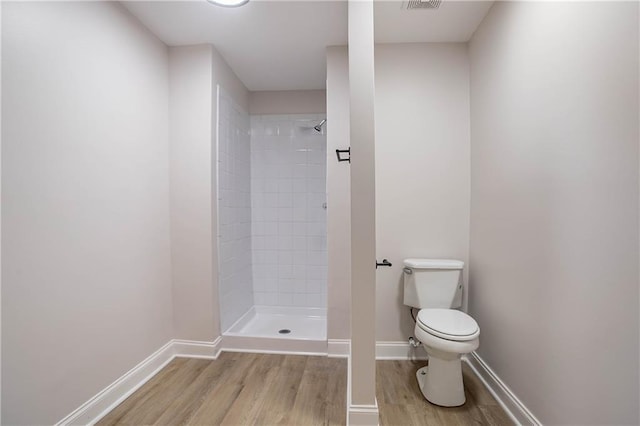 5096 Limerick Ln, Flowery Branch, GA 30542 - full bathroom featuring toilet, wood finished floors, a shower stall, and baseboards
