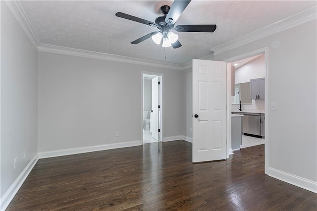 5096 Limerick Ln, Flowery Branch, GA 30542 - empty room featuring a ceiling fan, dark wood-style floors, baseboards, crown molding, and a textured ceiling