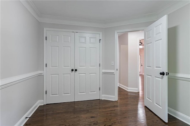 5096 Limerick Ln, Flowery Branch, GA 30542 - unfurnished bedroom featuring dark wood finished floors, a closet, ornamental molding, and baseboards