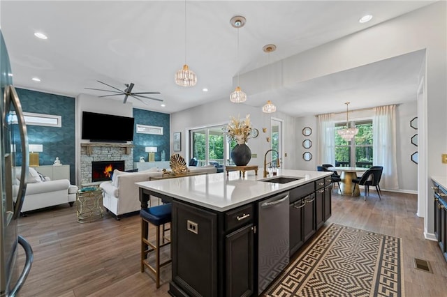 kitchen featuring a sink, stainless steel dishwasher, dark wood finished floors, a ceiling fan, and recessed lighting