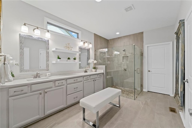 bathroom with a shower stall, double vanity, tile patterned floors, and recessed lighting