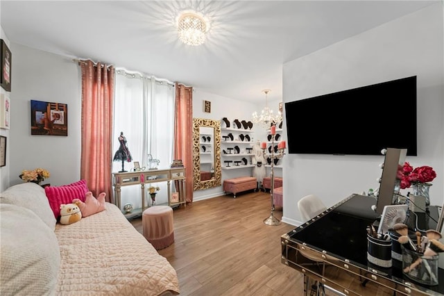bedroom with a chandelier and wood finished floors